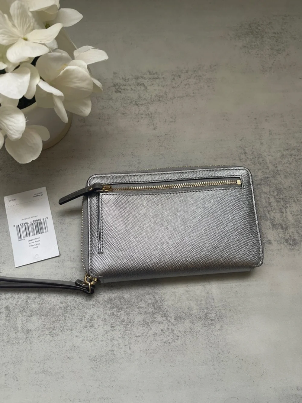 Kate Spade Laurie silver zip-around wristlet wallet